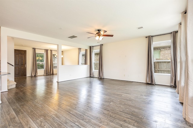 unfurnished living room featuring ceiling fan, stairs, and hardwood / wood-style floors