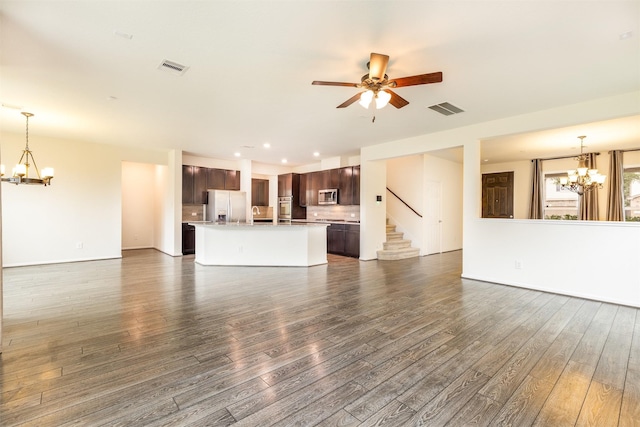 unfurnished living room with a chandelier, dark wood finished floors, a ceiling fan, and recessed lighting