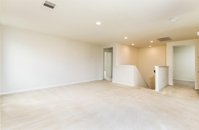 unfurnished room with recessed lighting, light colored carpet, baseboards, and a smoke detector