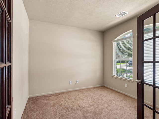 2513 Crestmoon Ct, Houston, TX 77089 - spare room featuring visible vents, carpet flooring, a textured ceiling, and baseboards