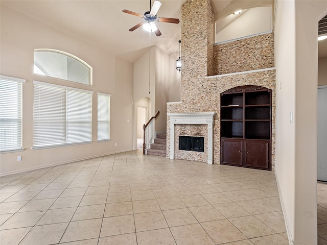 2513 Crestmoon Ct, Houston, TX 77089 - unfurnished living room with ceiling fan, tile patterned flooring, high vaulted ceiling, built in shelves, and baseboards