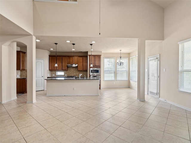 2513 Crestmoon Ct, Houston, TX 77089 - unfurnished living room featuring recessed lighting, arched walkways, a towering ceiling, and light tile patterned flooring