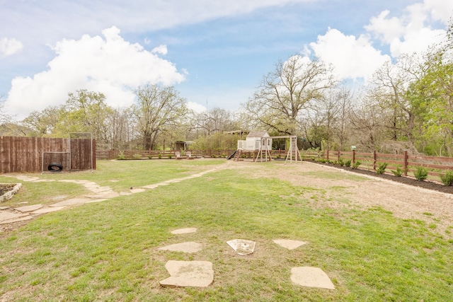view of yard with a playground and fence