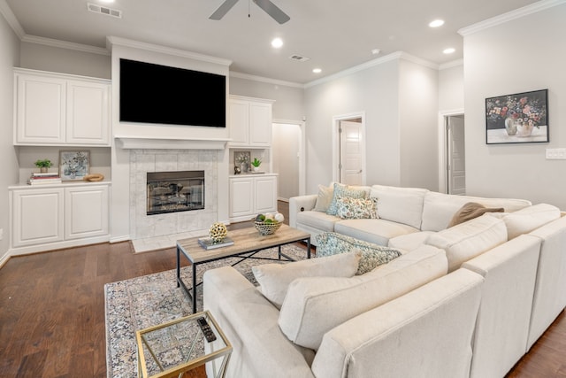 living area with ceiling fan, visible vents, a tile fireplace, recessed lighting, and dark wood-type flooring