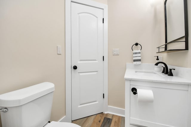 23058 Mills Rd, Porter, TX 77365 - half bathroom with vanity, baseboards, toilet, and wood finished floors