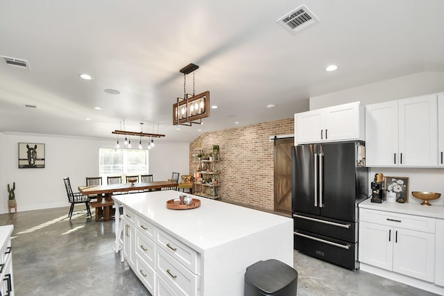 23058 Mills Rd, Porter, TX 77365 - kitchen featuring visible vents, brick wall, high end black refrigerator, light countertops, and white cabinets