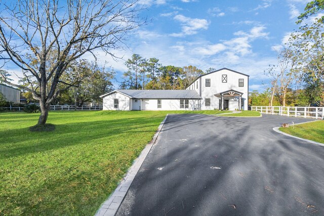 23058 Mills Rd, Porter, TX 77365 - view of front of property featuring fence, driveway, and a front yard
