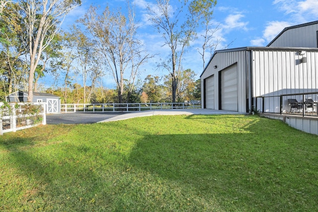 23058 Mills Rd, Porter, TX 77365 - view of yard featuring an outdoor structure, a garage, fence, and driveway