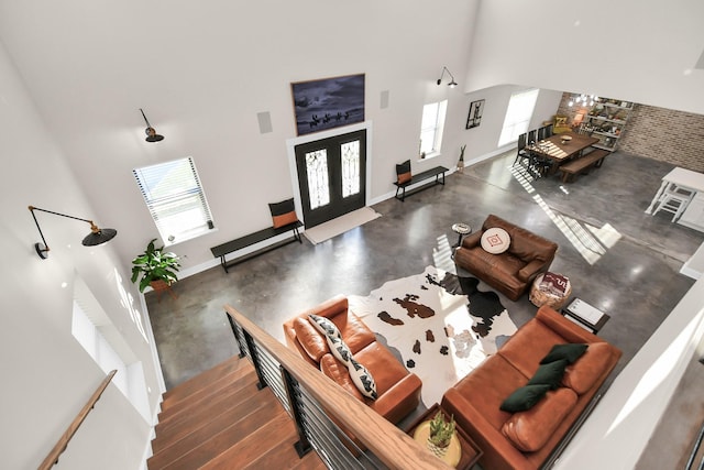 23058 Mills Rd, Porter, TX 77365 - living area with baseboards, concrete flooring, and high vaulted ceiling