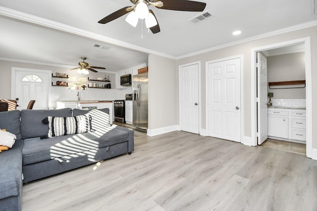 23058 Mills Rd, Porter, TX 77365 - living area with visible vents, a ceiling fan, and light wood-style flooring