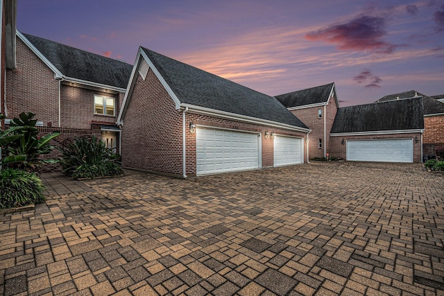 2722 Masters Dr, League City, TX 77573 - garage at dusk featuring decorative driveway