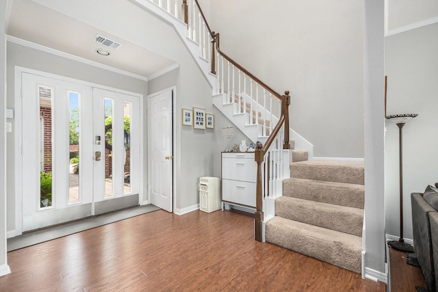2722 Masters Dr, League City, TX 77573 - foyer with visible vents, wood finished floors, stairway, baseboards, and ornamental molding