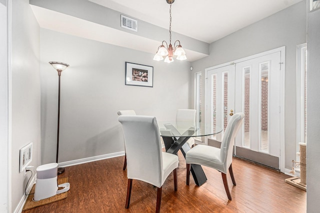 2722 Masters Dr, League City, TX 77573 - dining room featuring visible vents, an inviting chandelier, wood finished floors, baseboards, and french doors