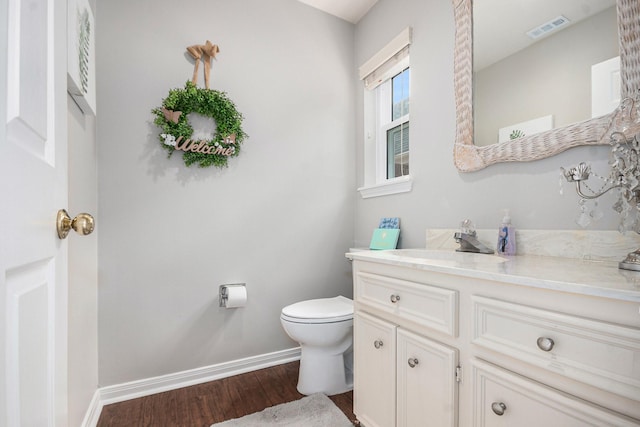 2722 Masters Dr, League City, TX 77573 - bathroom featuring visible vents, vanity, wood finished floors, toilet, and baseboards