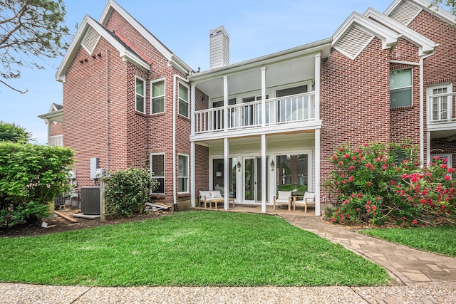 2722 Masters Dr, League City, TX 77573 - rear view of property with a lawn, central air condition unit, brick siding, and a balcony