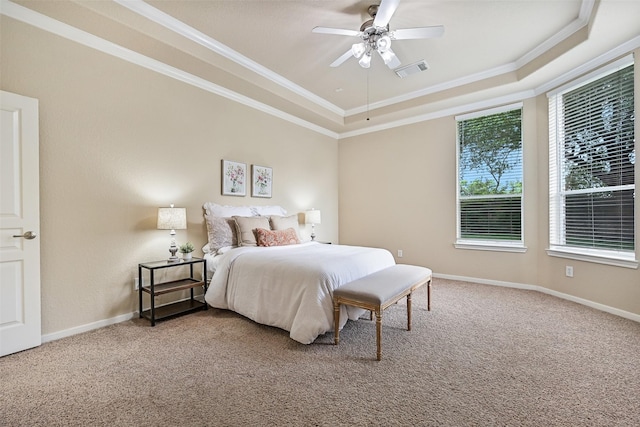 bedroom with visible vents, carpet, a raised ceiling, and crown molding