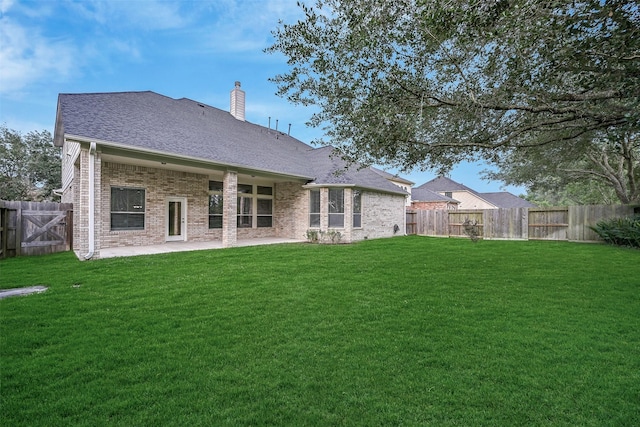 2524 Garnetfield Ln, Friendswood, TX 77546 - back of property with brick siding, a chimney, a patio, and roof with shingles