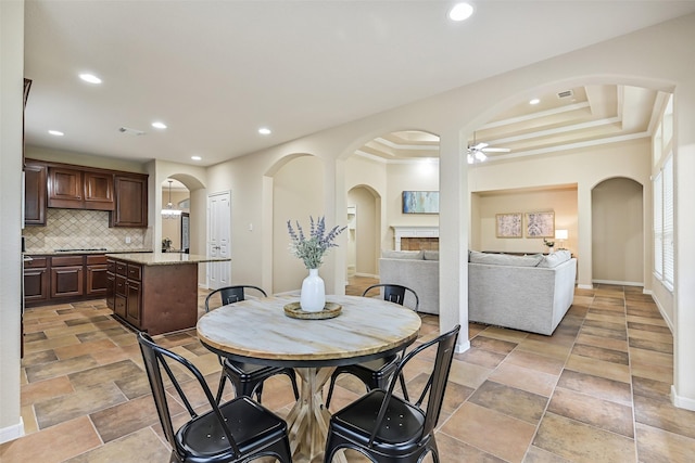 2524 Garnetfield Ln, Friendswood, TX 77546 - dining area featuring ceiling fan, recessed lighting, arched walkways, and stone finish flooring