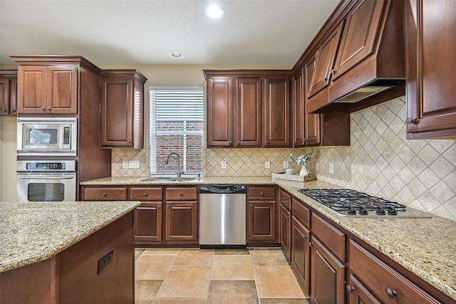 2524 Garnetfield Ln, Friendswood, TX 77546 - kitchen featuring stainless steel appliances, a sink, light stone counters, tasteful backsplash, and recessed lighting