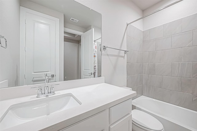 full bathroom featuring toilet, visible vents, shower / bath combo, and vanity