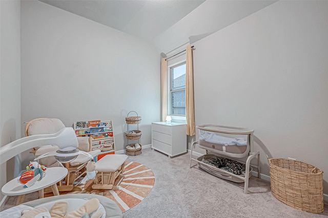 bedroom with carpet floors, baseboards, and vaulted ceiling