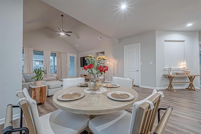 dining space with a ceiling fan, baseboards, recessed lighting, wood finished floors, and vaulted ceiling