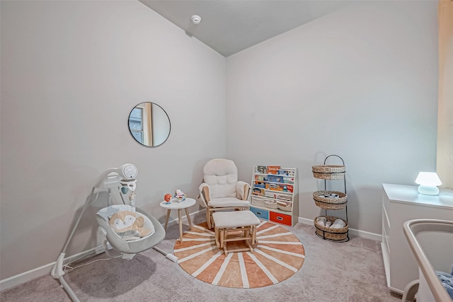 living area with baseboards and carpet