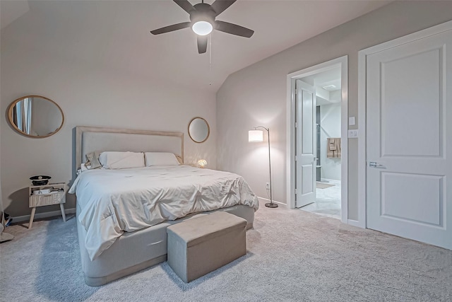 bedroom with ceiling fan, baseboards, lofted ceiling, carpet, and ensuite bath