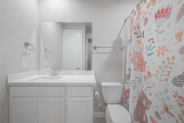 bathroom featuring vanity, a shower with curtain, and toilet