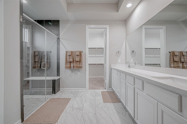 full bathroom with a sink, a stall shower, and marble finish floor