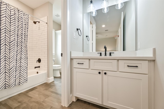 bathroom with vanity, toilet, visible vents, and shower / tub combo with curtain