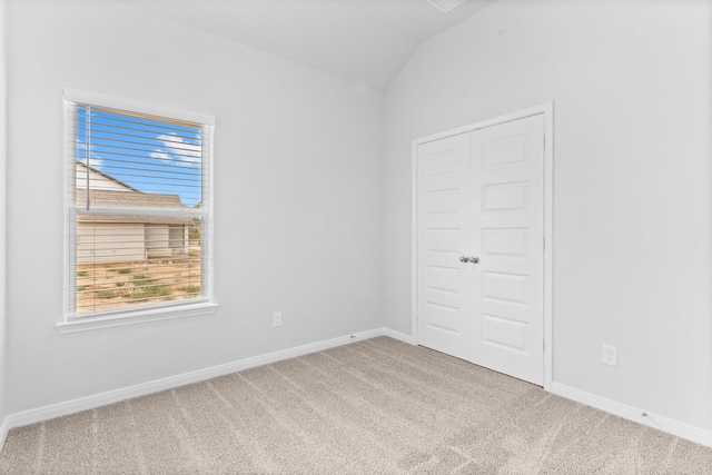 11869 E Gate Dr, Willis, TX 77318 - empty room featuring carpet floors, plenty of natural light, baseboards, and lofted ceiling