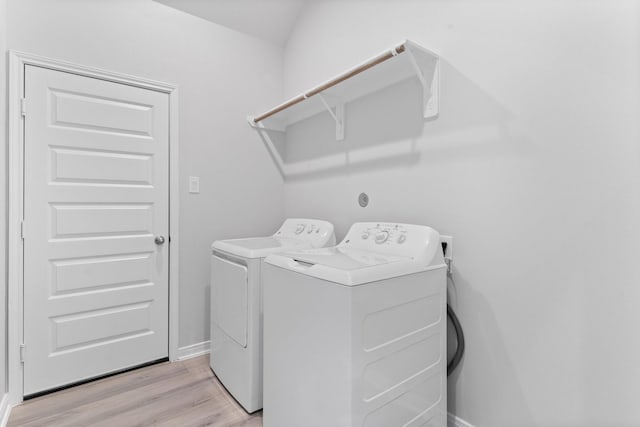 11869 E Gate Dr, Willis, TX 77318 - laundry room featuring washer and dryer, laundry area, baseboards, and light wood-style floors