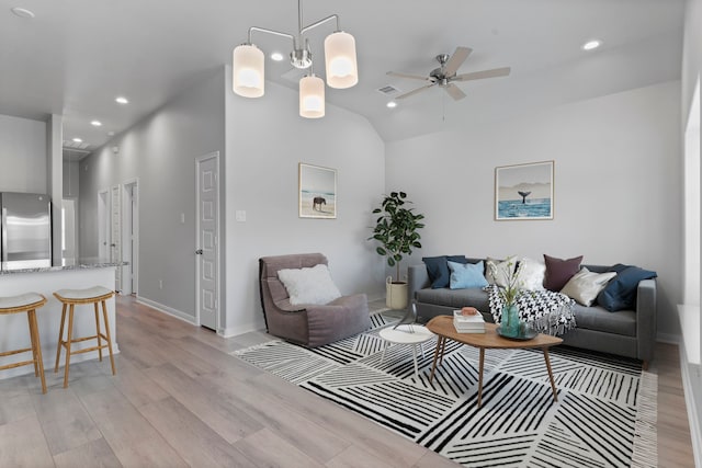 11869 E Gate Dr, Willis, TX 77318 - living room featuring lofted ceiling, light wood-style floors, baseboards, ceiling fan, and recessed lighting