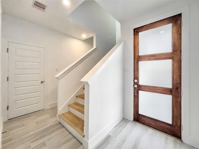 7705 Westside Villas Ln, Houston, TX 77055 - foyer entrance with baseboards, visible vents, stairway, and light wood-type flooring