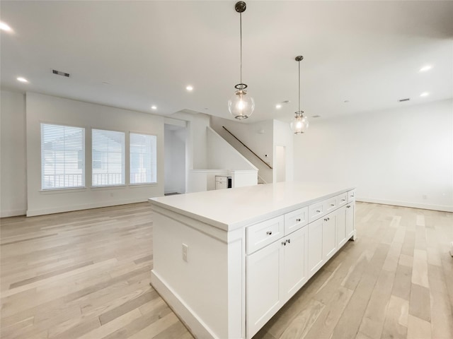 7705 Westside Villas Ln, Houston, TX 77055 - kitchen with light wood-type flooring, a center island, and open floor plan