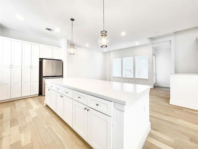 7705 Westside Villas Ln, Houston, TX 77055 - kitchen featuring recessed lighting, freestanding refrigerator, light wood finished floors, and visible vents