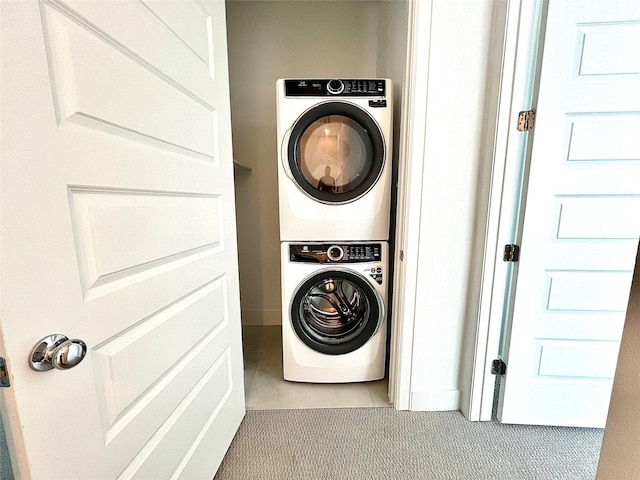7705 Westside Villas Ln, Houston, TX 77055 - clothes washing area featuring laundry area, tile patterned flooring, and stacked washer / drying machine