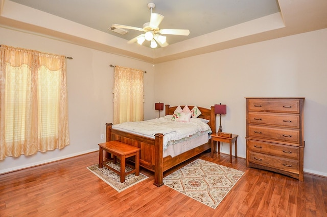 24242 Yelverton Glen Dr, Katy, TX 77493 - bedroom with baseboards, visible vents, wood finished floors, and a raised ceiling