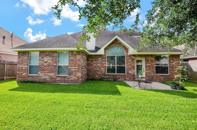 24242 Yelverton Glen Dr, Katy, TX 77493 - rear view of property with a yard, a patio, a shingled roof, and a fenced backyard