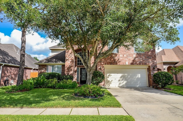 24242 Yelverton Glen Dr, Katy, TX 77493 - view of front of home featuring an attached garage, driveway, a front lawn, and brick siding