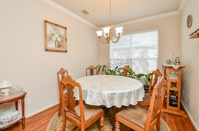 24242 Yelverton Glen Dr, Katy, TX 77493 - dining room with visible vents, ornamental molding, baseboards, light wood-style flooring, and a notable chandelier