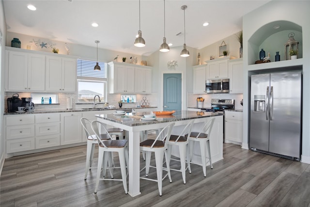 4413 Strand Ave, Port Bolivar, TX 77650 - kitchen featuring stainless steel appliances, a kitchen island, white cabinets, and recessed lighting