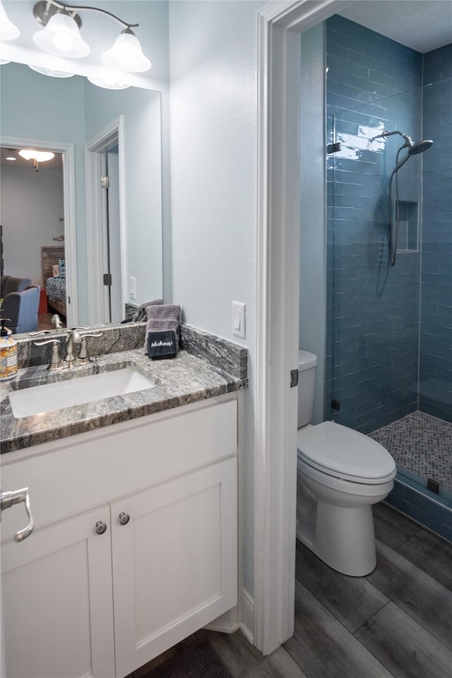 4413 Strand Ave, Port Bolivar, TX 77650 - full bath featuring a shower stall, ensuite bathroom, wood finished floors, vanity, and toilet