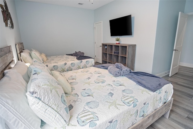 4413 Strand Ave, Port Bolivar, TX 77650 - bedroom featuring wood finished floors and baseboards