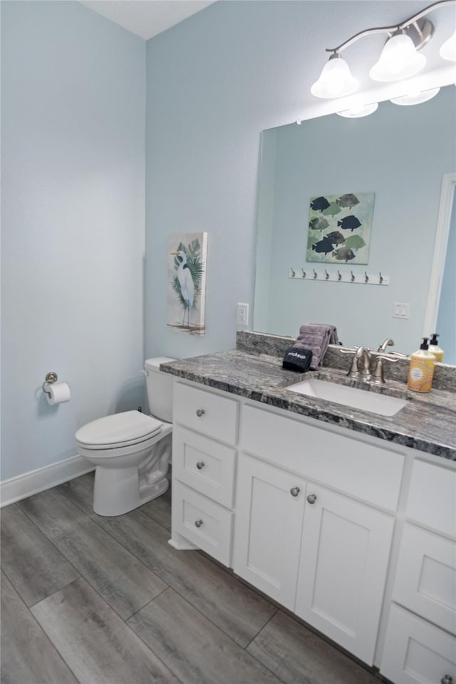 4413 Strand Ave, Port Bolivar, TX 77650 - bathroom with toilet, wood finished floors, and vanity