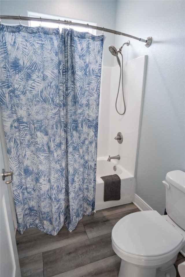 4413 Strand Ave, Port Bolivar, TX 77650 - full bathroom featuring wood finished floors, toilet, and shower / tub combo with curtain