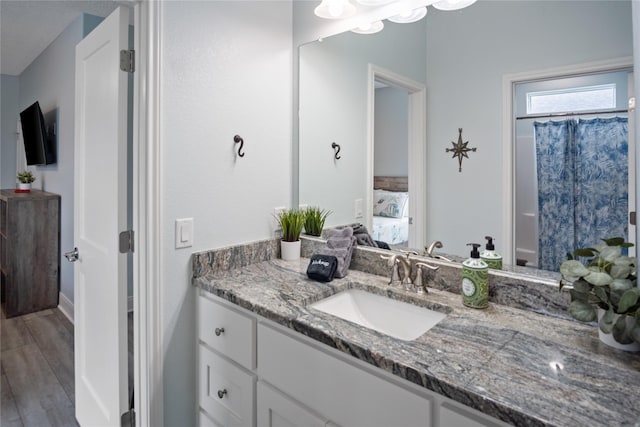 4413 Strand Ave, Port Bolivar, TX 77650 - ensuite bathroom featuring vanity and wood finished floors