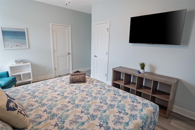 4413 Strand Ave, Port Bolivar, TX 77650 - bedroom with baseboards and wood finished floors