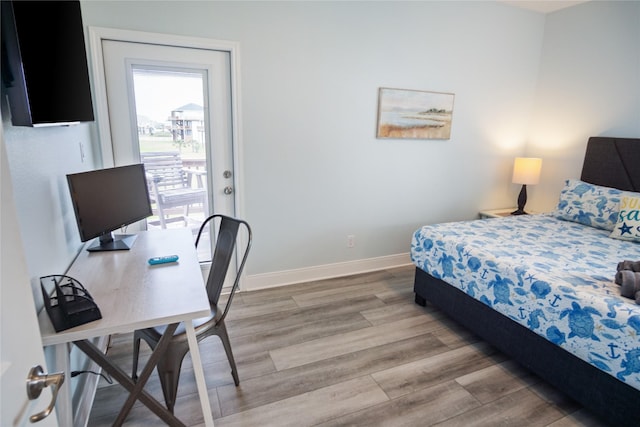 4413 Strand Ave, Port Bolivar, TX 77650 - bedroom featuring wood finished floors, baseboards, and an office area